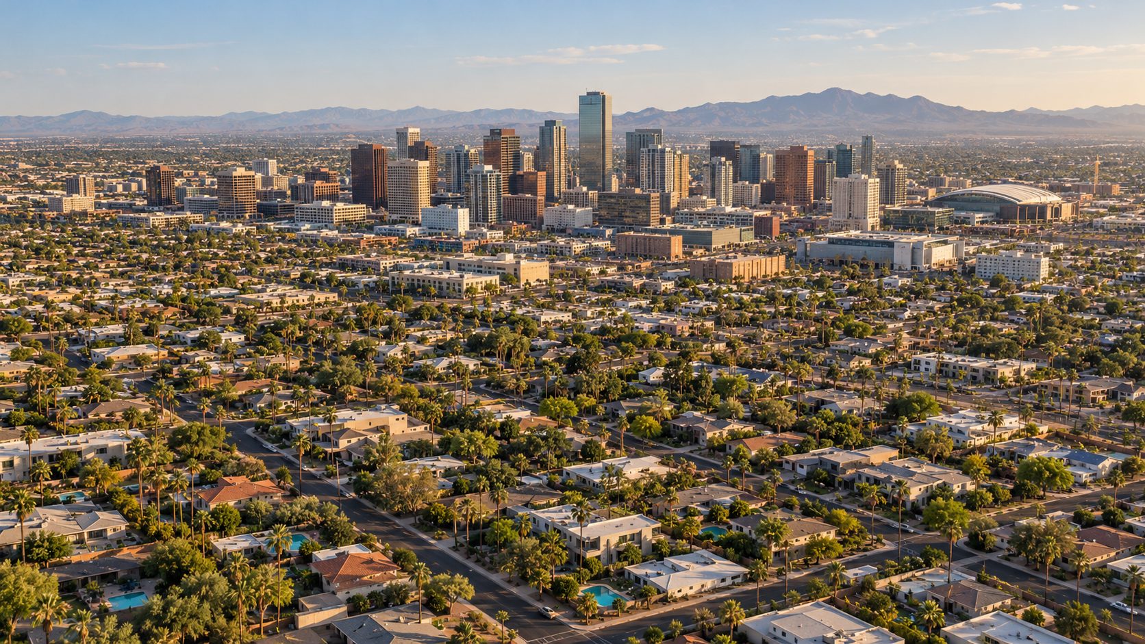 Aerial view of Phoenix homes with backyard pools and the downtown skyline